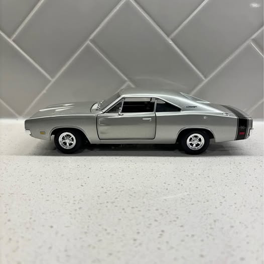 Silver 1969 muscle car diecast model, side view with black rear stripe
