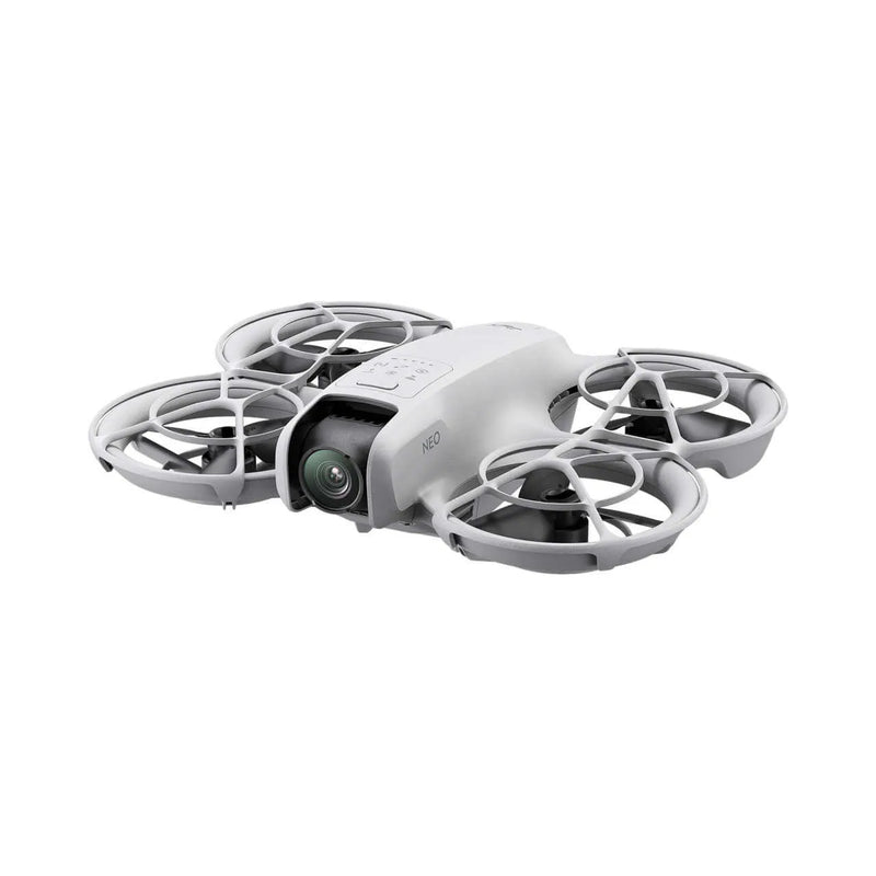 Portable mini drone with four propellers and protective prop guards, light gray