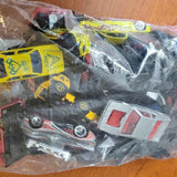 Assorted diecast car parts in clear plastic bag, yellow and red pieces