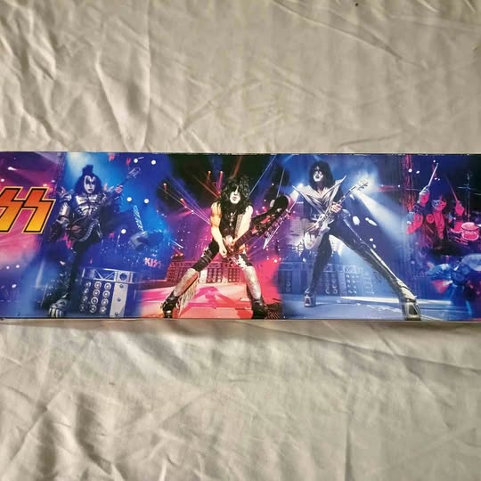 Diecast toy box with colorful rock band artwork and stage lights