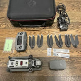 Drone quadcopter with camera, spare propellers, battery, charger, and carrying case