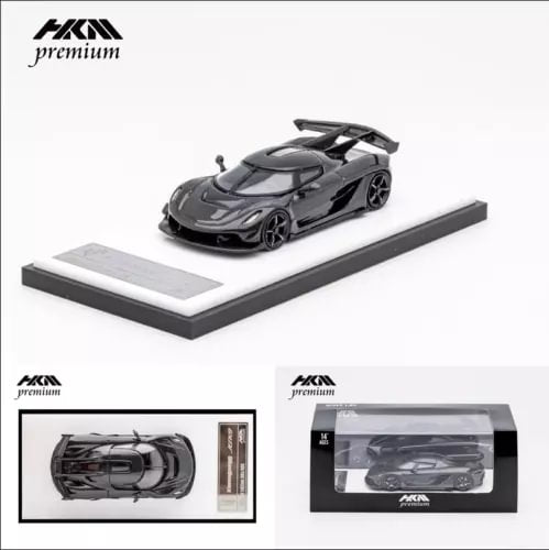 Black 1:64 diecast sports car model on display base with carbon-style detailing