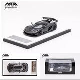Black 1:64 diecast sports car model on display base with carbon-style detailing
