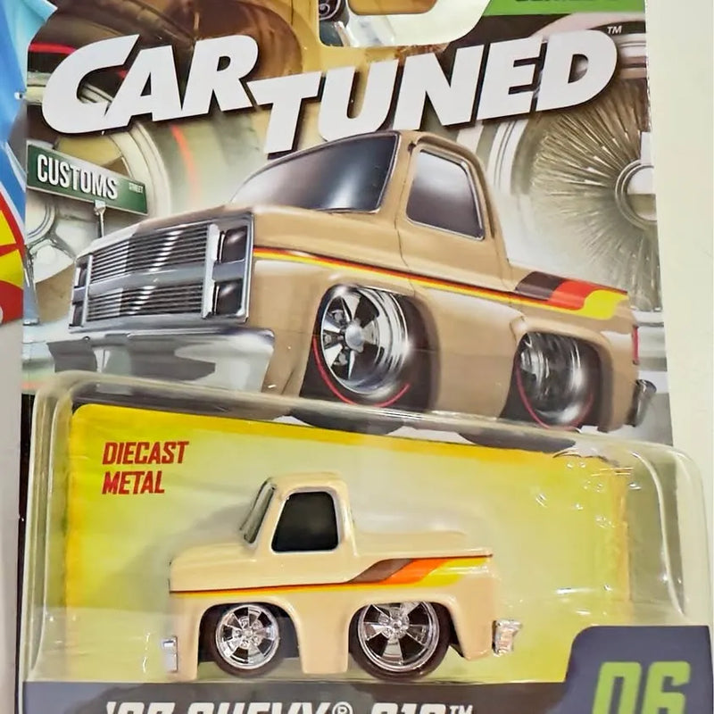 Diecast metal toy pickup truck with chrome grille and wheels, yellow with cream cab
