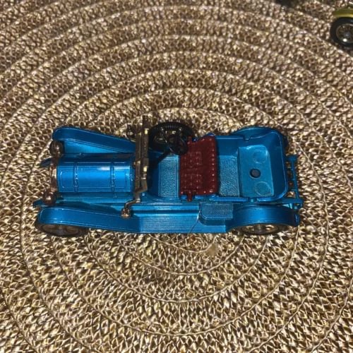 Blue diecast toy car model with red interior detail, front-side view.