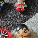 Kids toy drone with smiling character figure, black hair, big eyes, red details