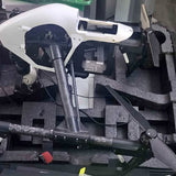 White and black drone frame with front landing legs and extended arm