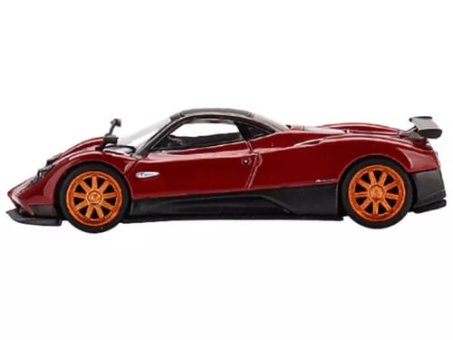 Red diecast sports car model with black aero kit and orange wheels, side view