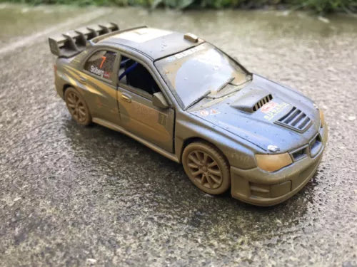 Gold and silver diecast toy rally car with open hood details and front grille