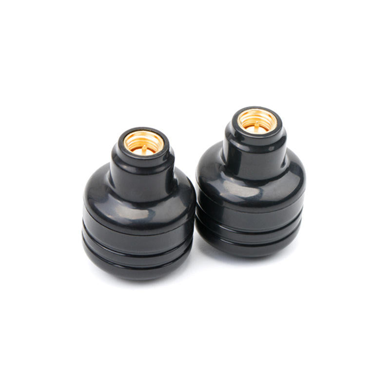 Pair of black mushroom antennas with gold center terminals