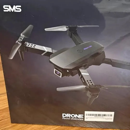 Gray quadcopter drone with four rotors and foldable arms