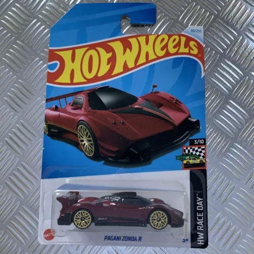 Red and burgundy diecast car on Hot Wheels card, side view, 1:64 scale