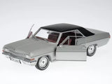 Silver diecast coupe model car with open door, front and side view
