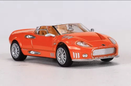 Orange 1/64 scale diecast sports car model with open details, front three-quarter view
