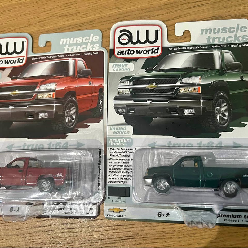 Premium diecast Chevy Silverado trucks in blister packages, red and dark green
