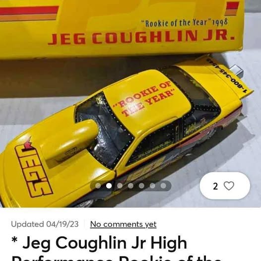 Yellow diecast pro stock car with black windows and hood decal, front 3/4 view