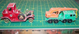 Red diecast crane truck and orange-and-teal diecast crane vehicle, 2-piece side view