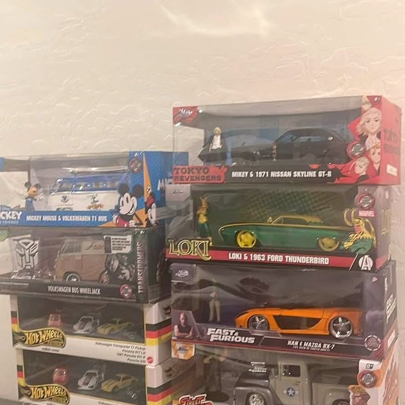 Diecast boxed toy cars with green and orange sports car, multiple packages