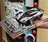 White and black 1:64 die-cast racing sports car model with glossy detailing