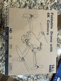 4K camera drone box with foldable quadcopter illustration
