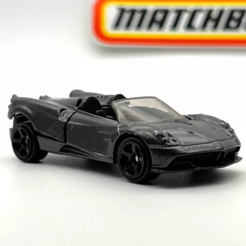 Die-cast roadster car with open top, dark gray body, black wheels