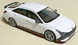 White 1:64 diecast car model, side view with black alloy wheels