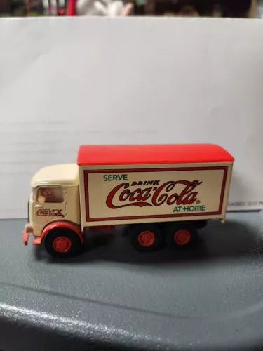 Diecast delivery truck with Coca-Cola logo, red cab and cream box.