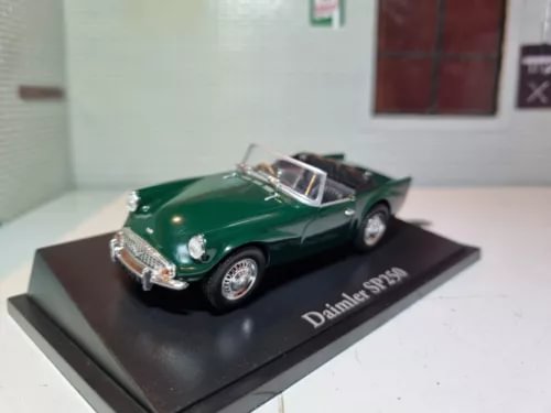 Green Daimler SP250 convertible diecast model car on display base with chrome details