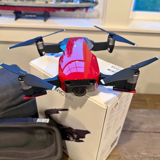 DJI Mavic Air drone with flaming red body and blue propeller arms