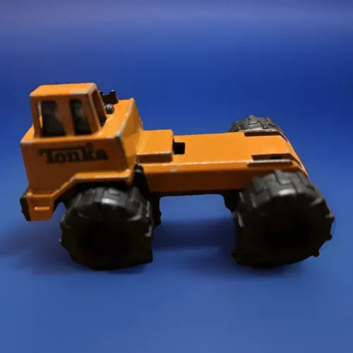 Orange metal diecast mini construction tractor truck with large black wheels