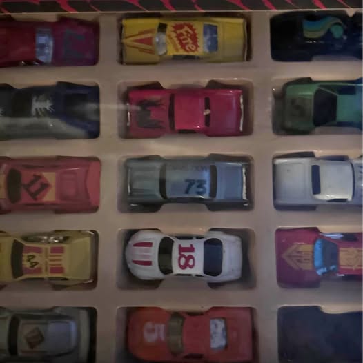Diecast car assortment in plastic display tray, multi-color race cars