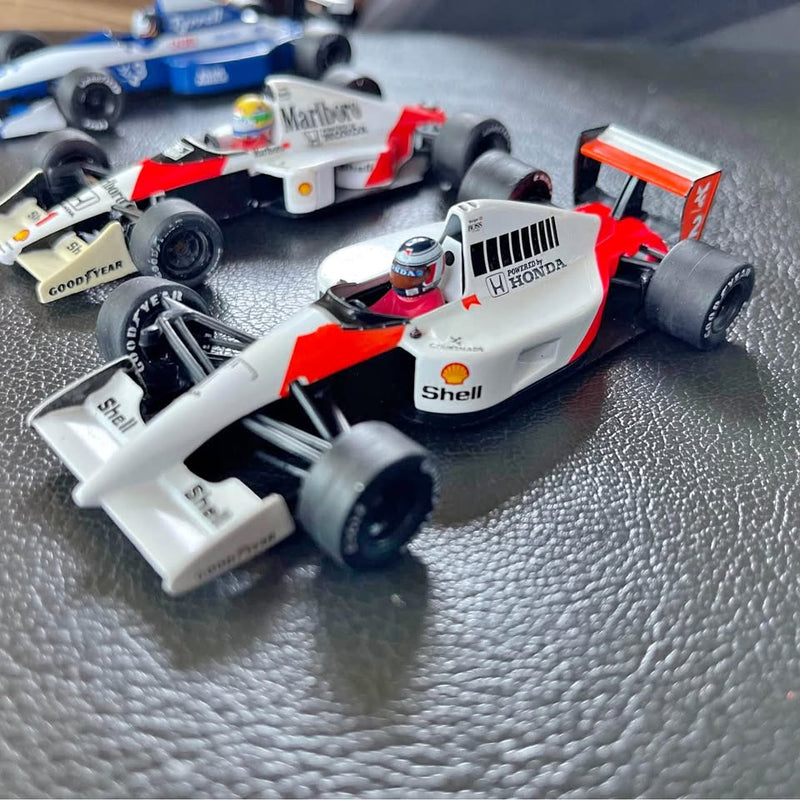 White and red Honda F1 diecast model car with front wing and wheels