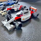 White and red Honda F1 diecast model car with front wing and wheels