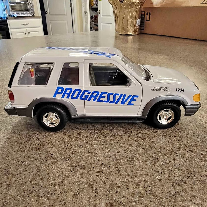 Diecast Ford IRV vehicle with Progressive graphics, light gray, black wheels