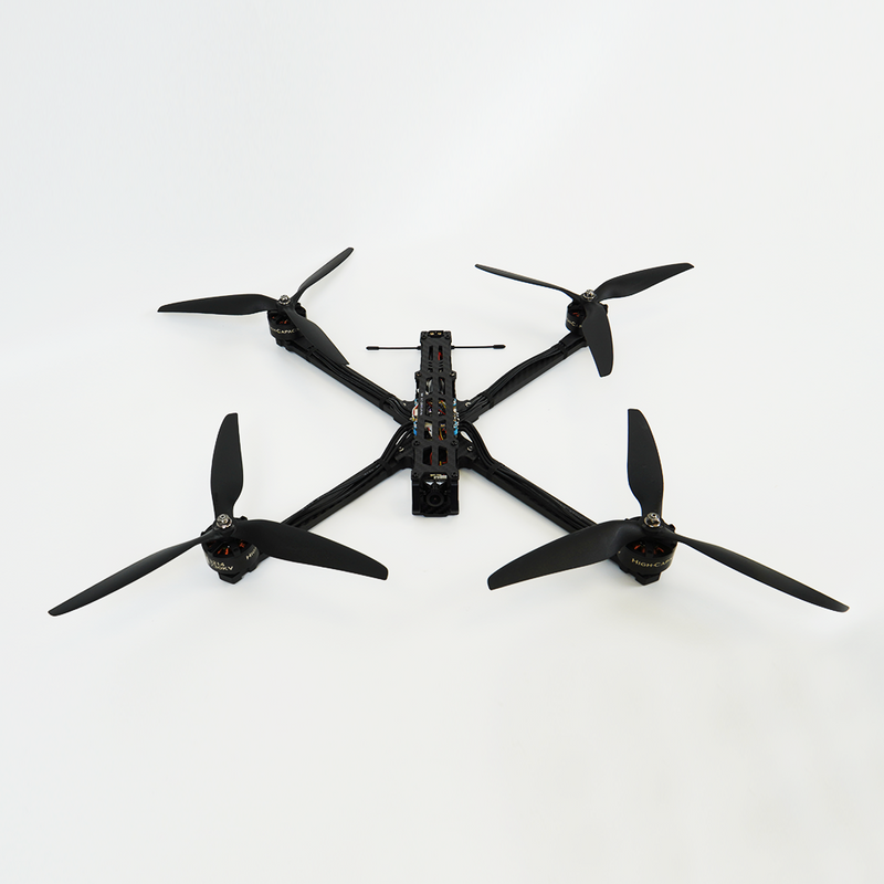Black quadcopter drone with four propellers and central controller module