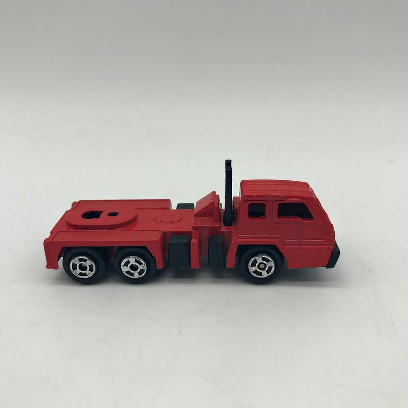 Red diecast crane semi truck toy with cab and crane boom, side view