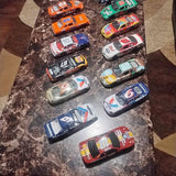 Diecast NASCAR stock car set with multiple numbered cars in assorted liveries