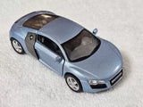 Audi R8 blue-gray diecast toy car, front three-quarter view with open doors