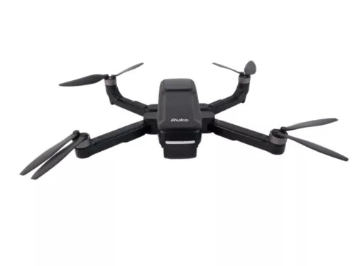 Drone with foldable quadcopter arms and front camera module, dark body