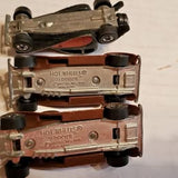 Hot Wheels diecast toy car, brown with metal details and visible Hot Wheels badge