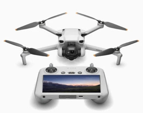 DJI Mini drone with four propellers and white controller with display