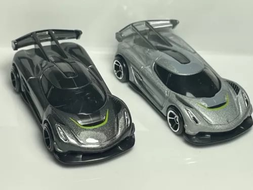 Set of 2 diecast model cars, dark gray and silver with green stripe accents