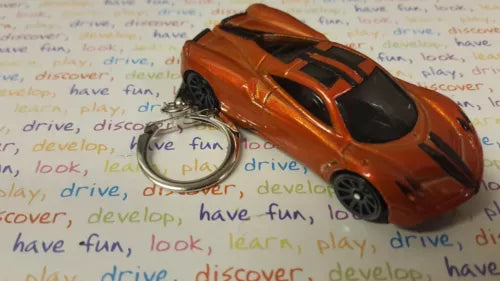 Bronze diecast toy car keychain with black hood and orange stripe detailing