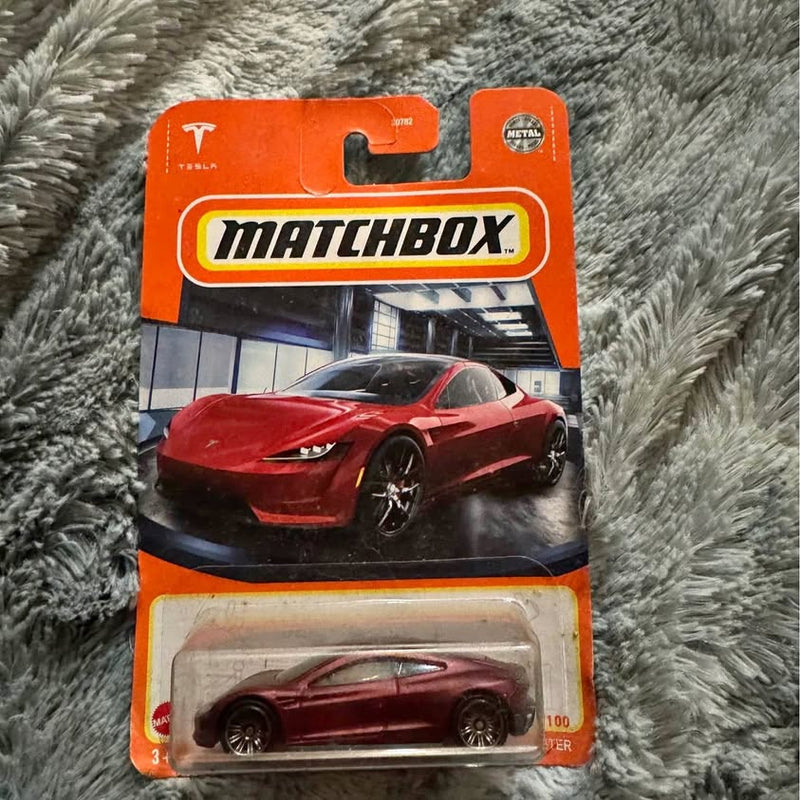 Matchbox red Tesla Roadster diecast in blister package, front view on card