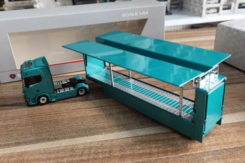 Teal diecast transport truck model with open-frame cargo bed, front cab visible