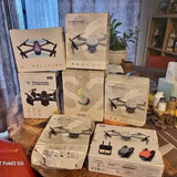 Assorted drone boxes and small drones in retail packaging