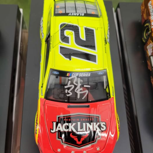 Autographed diecast race car in neon yellow and red with Jack Links logo