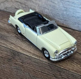 Cream convertible diecast toy car with black interior and chrome front