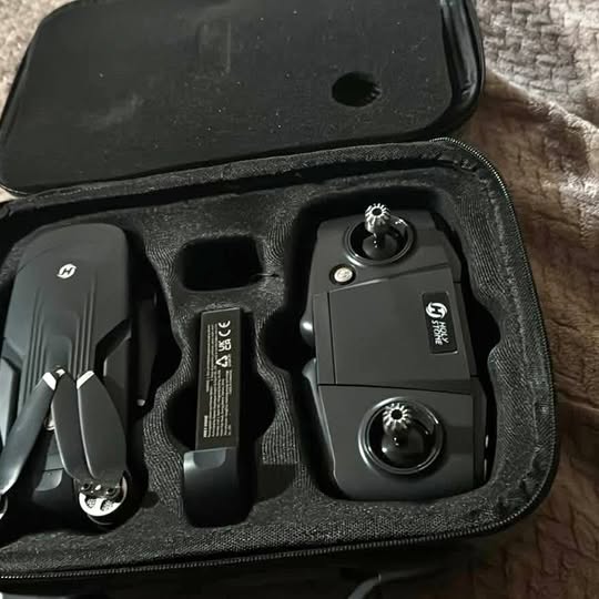 Black drone remote controller and accessories in zip-up carrying case