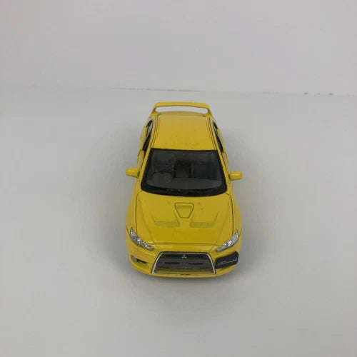 Yellow diecast race car model, front view, 1:36 scale, Evo-style with black windshield